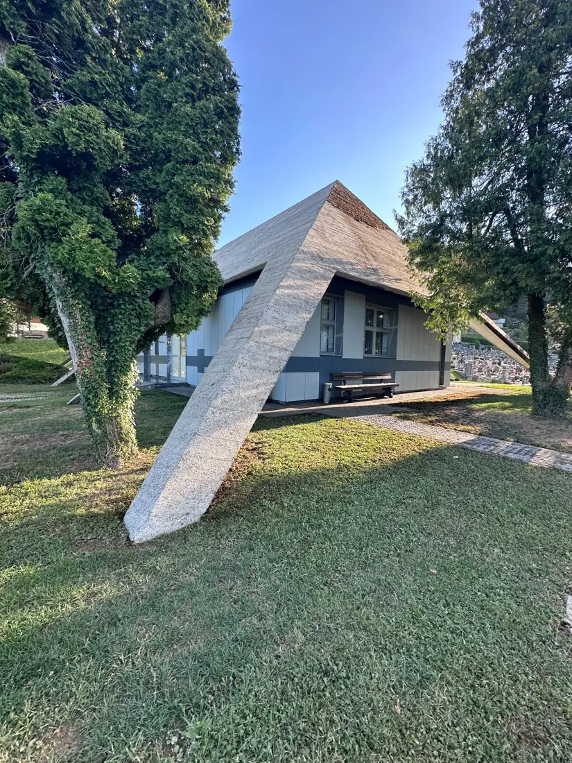 Širši pogled na betonsko fasado in površine okoli objekta.